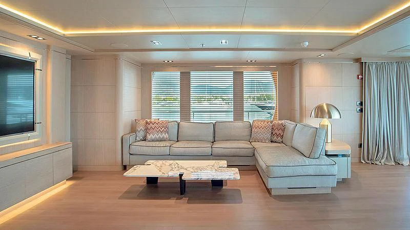 a living room with a couch and a table aboard JAZ Yacht for Charter