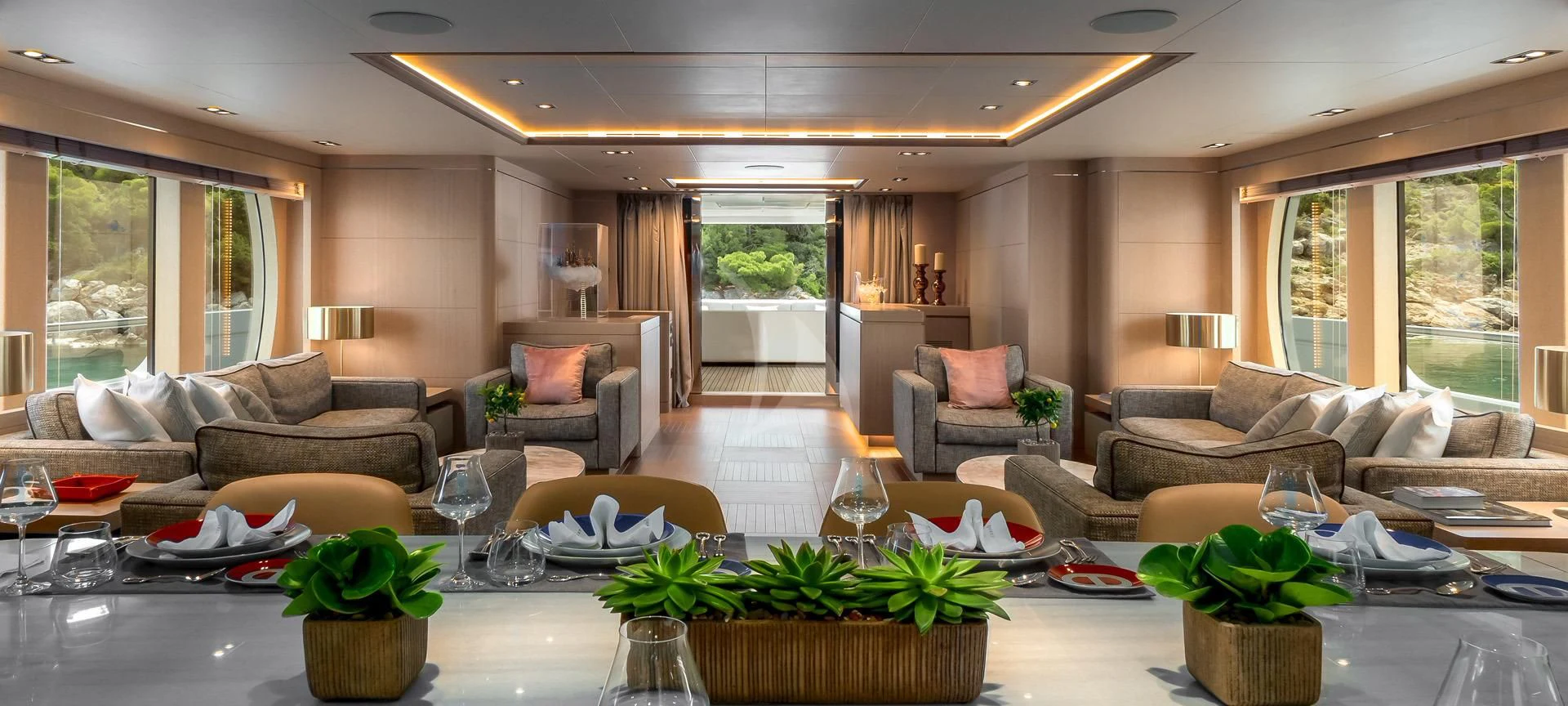 a living room with a large table and chairs aboard JAZ Yacht for Charter