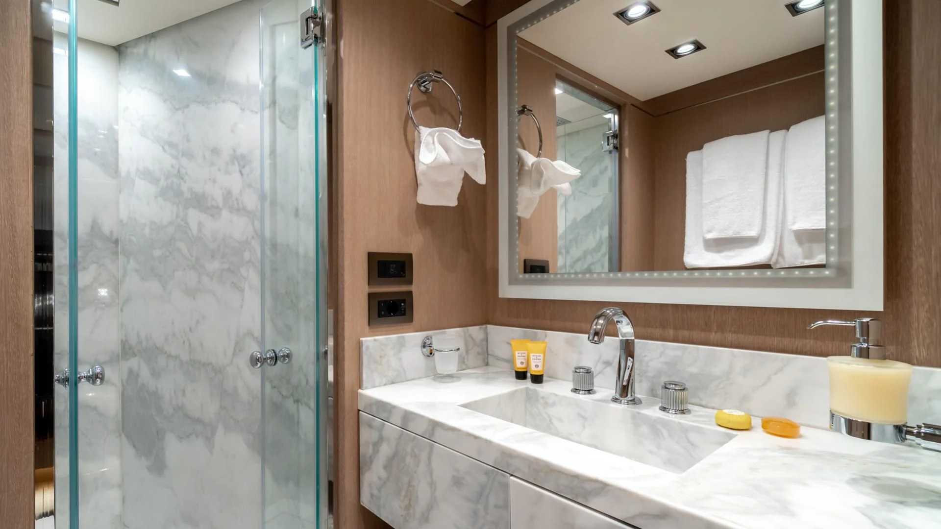 a bathroom with a large mirror aboard JAZ Yacht for Charter
