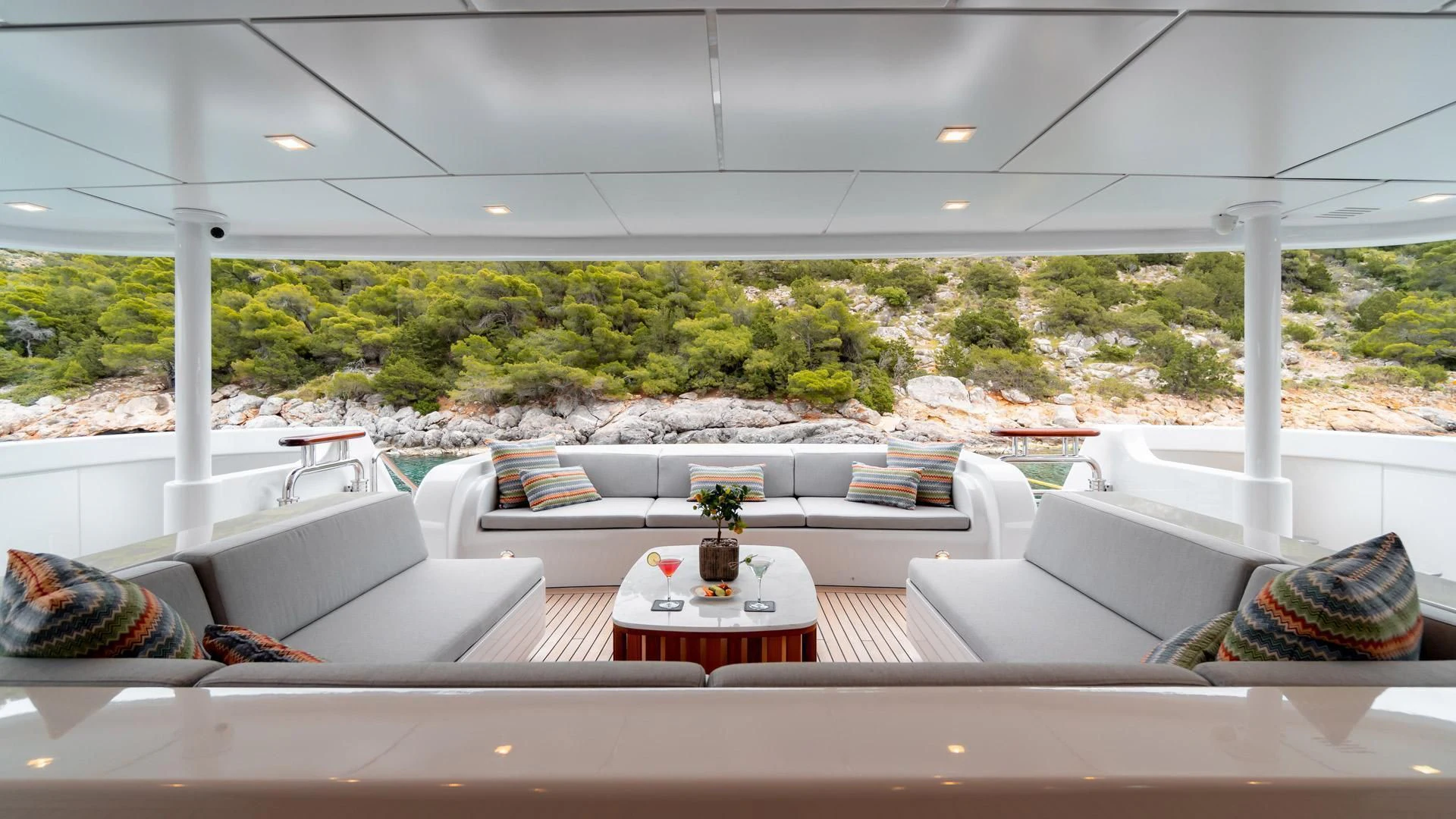 a room with a table and couches aboard JAZ Yacht for Charter