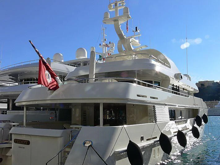 a large white boat with flags on it aboard JAZ Yacht for Charter