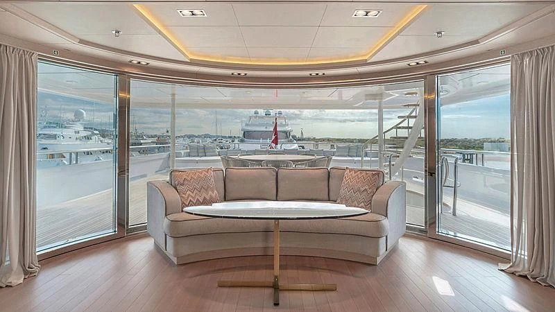 a living room with a large glass door aboard JAZ Yacht for Charter