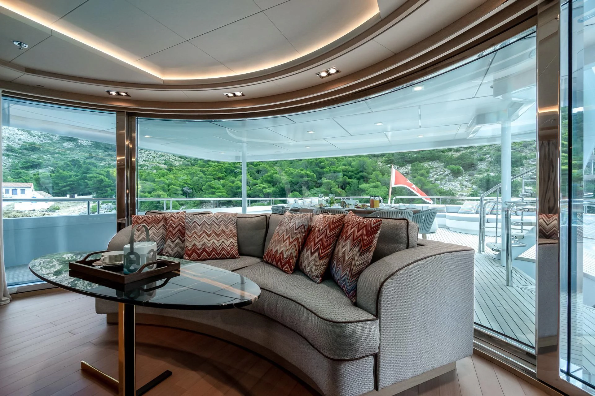 a couch and table in a room aboard JAZ Yacht for Charter