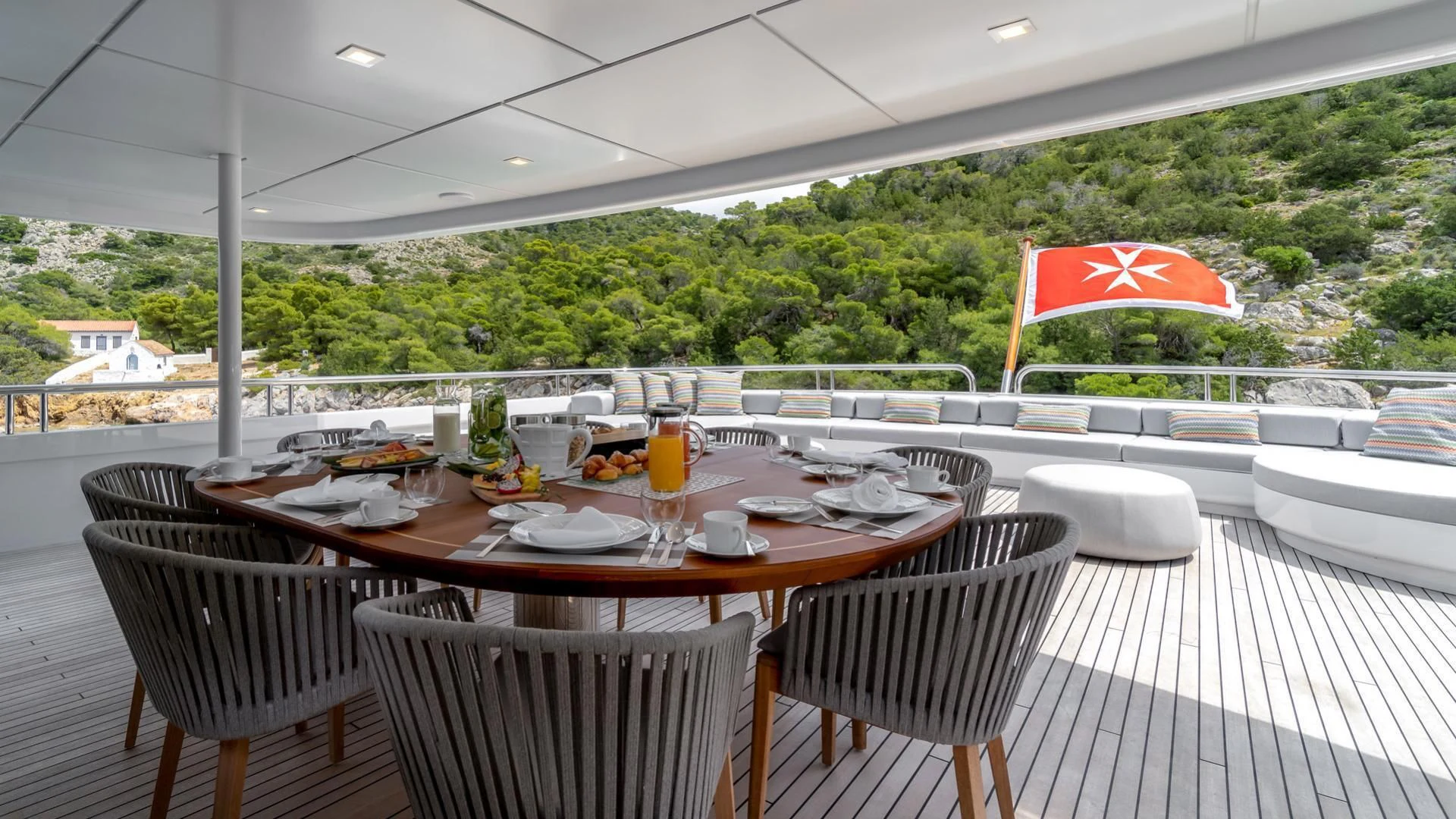 a table set with plates and glasses aboard JAZ Yacht for Charter