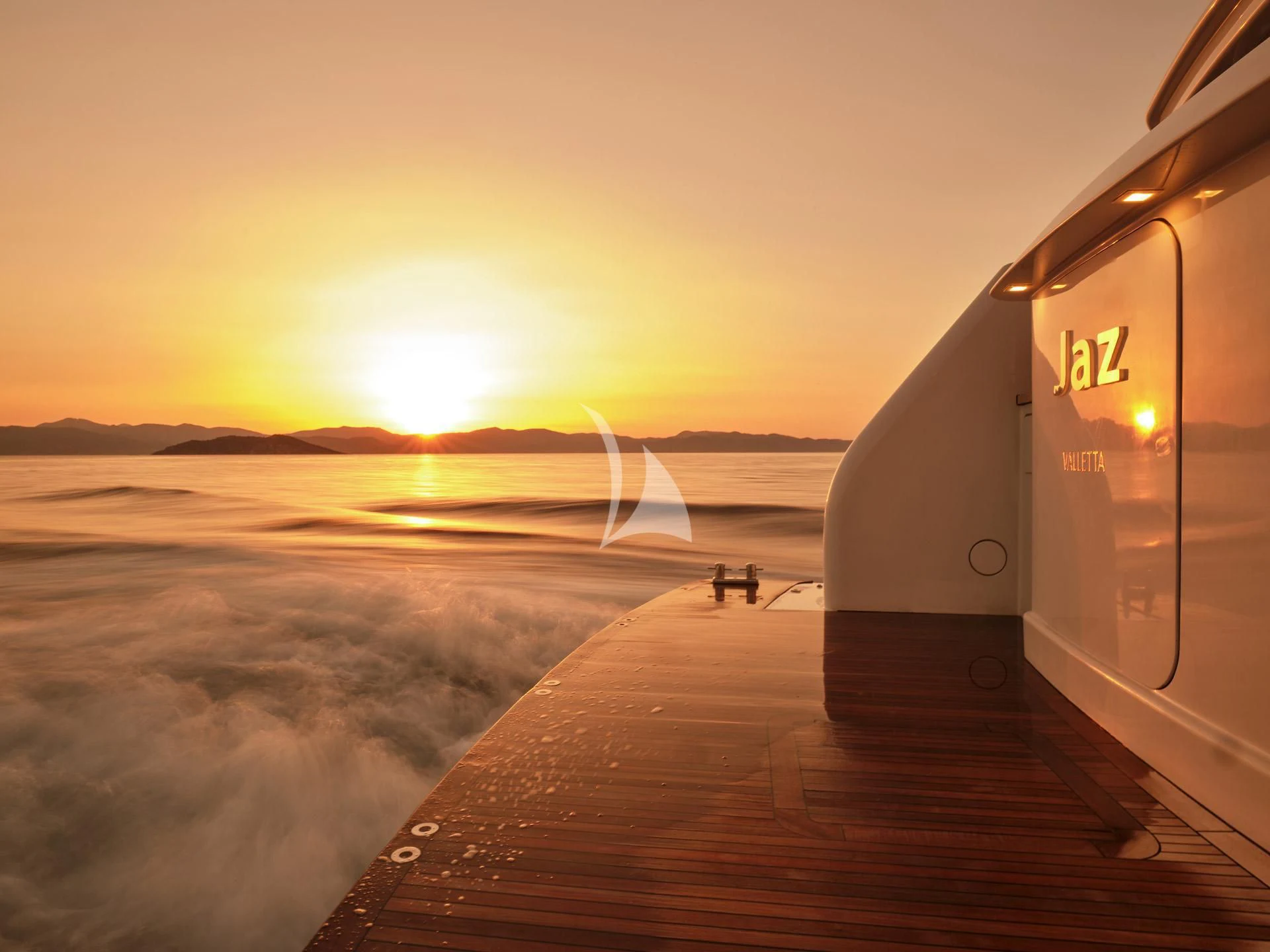 a person sitting on a bench next to a plane aboard JAZ Yacht for Charter