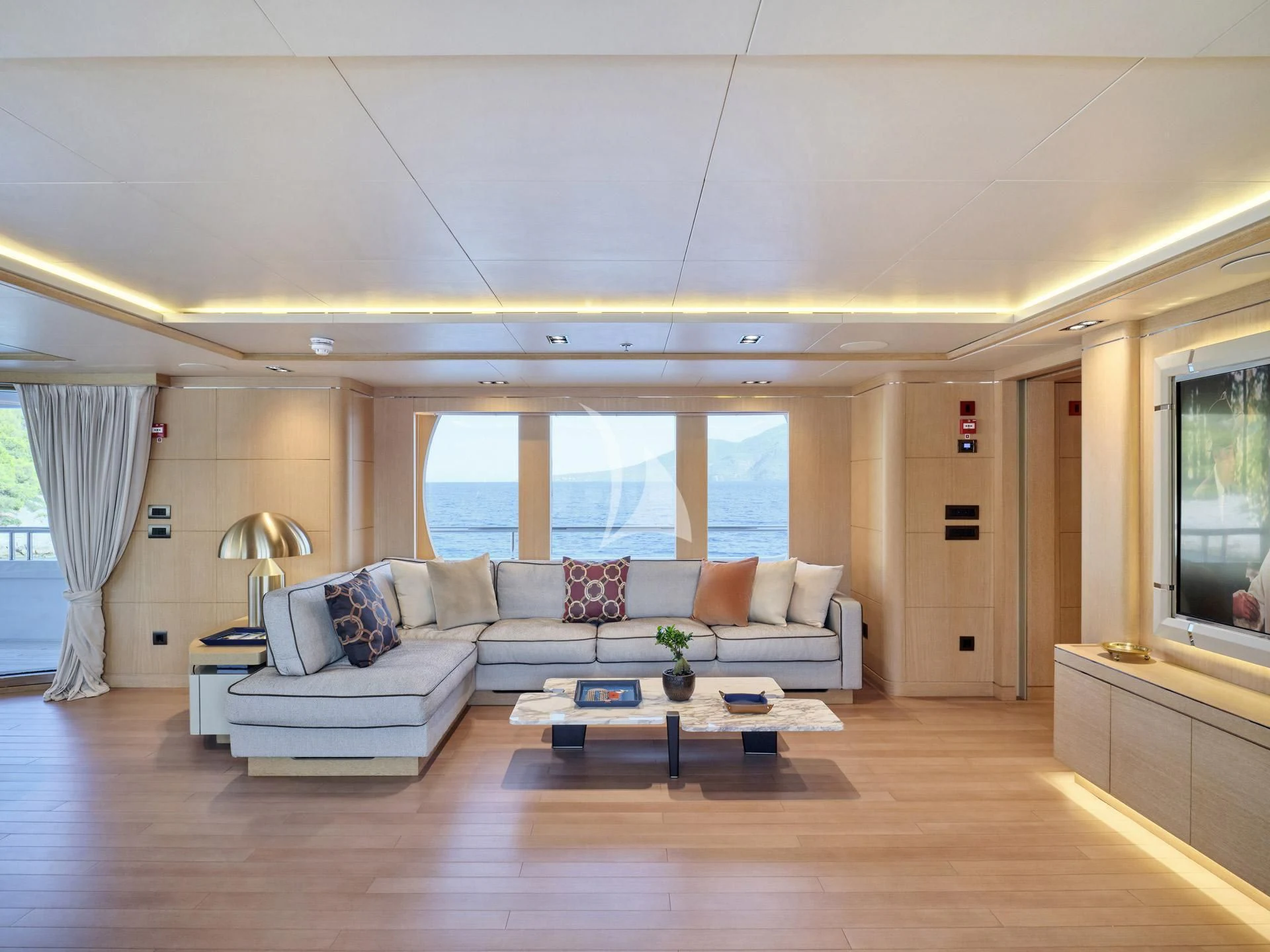 a living room with a large window aboard JAZ Yacht for Charter