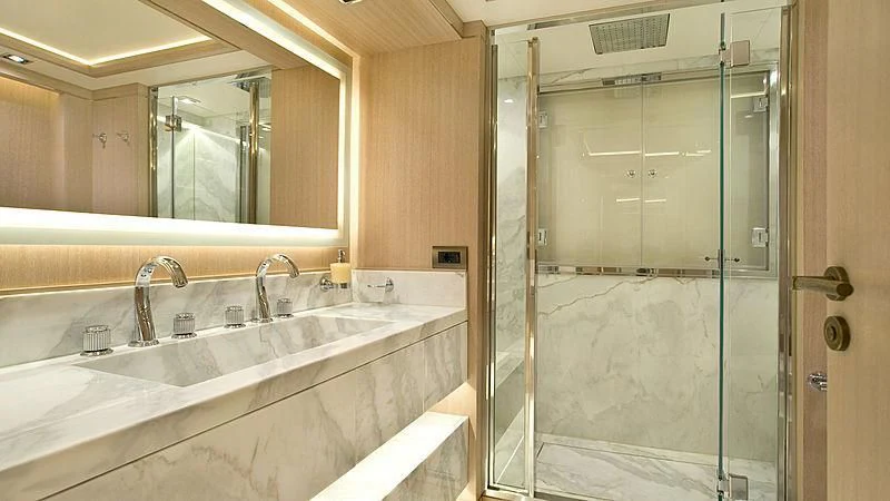 a bathroom with a glass shower aboard JAZ Yacht for Charter