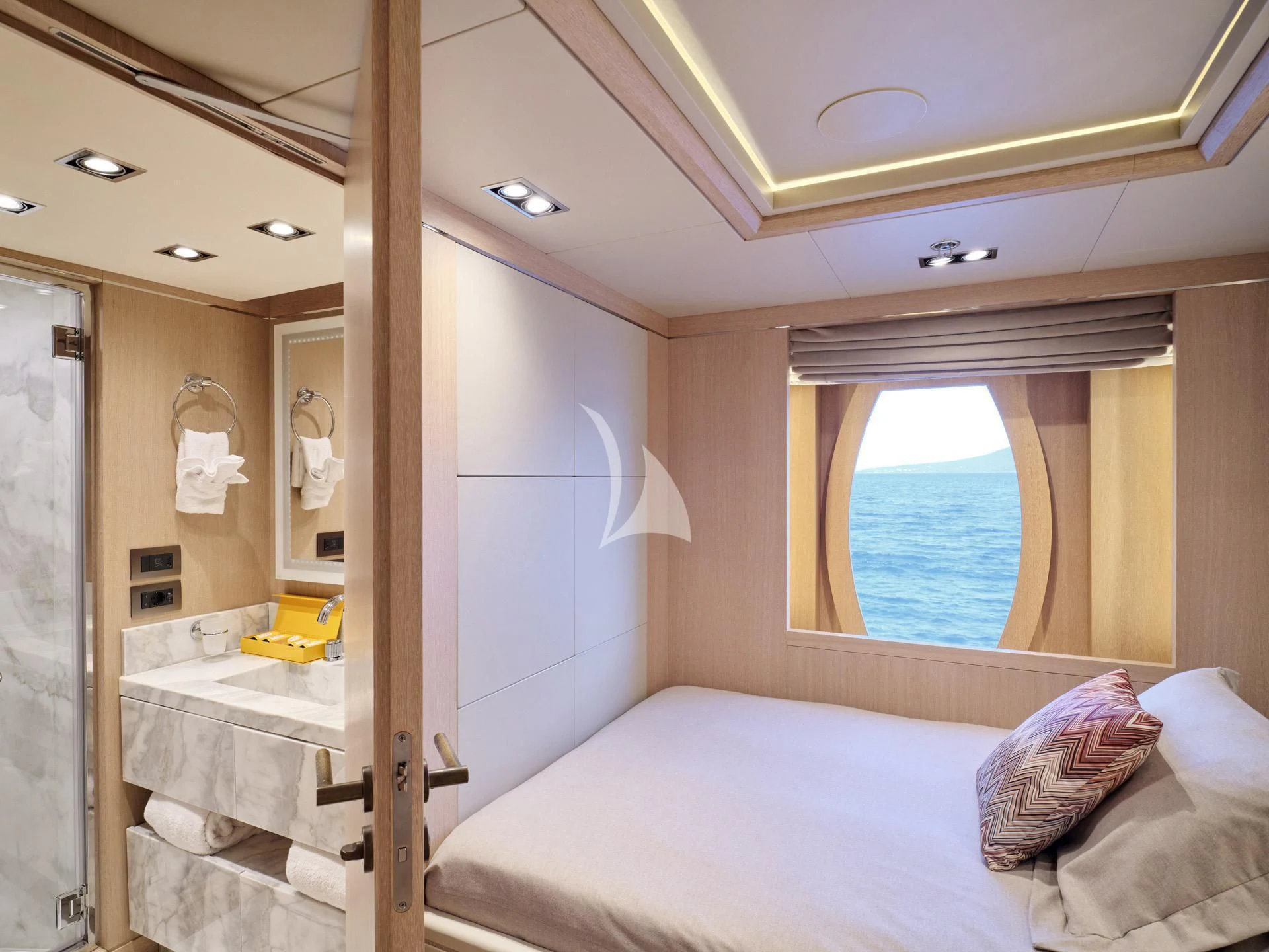 a bedroom with a bed and a mirror aboard JAZ Yacht for Charter
