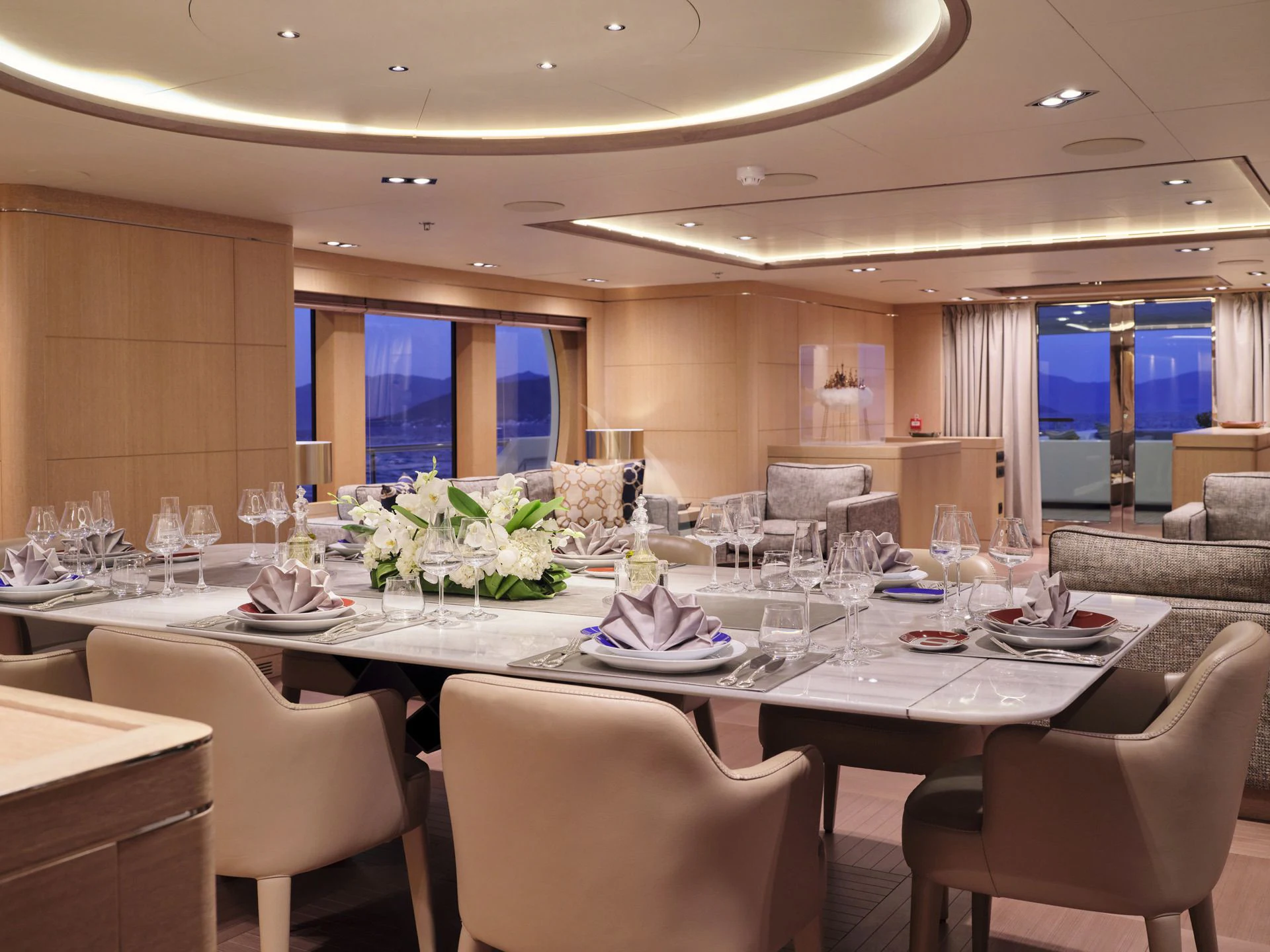 a large table with many plates and glasses on it aboard JAZ Yacht for Charter