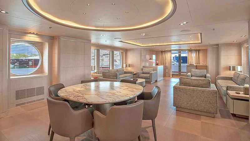a large living room with a table and chairs aboard JAZ Yacht for Charter