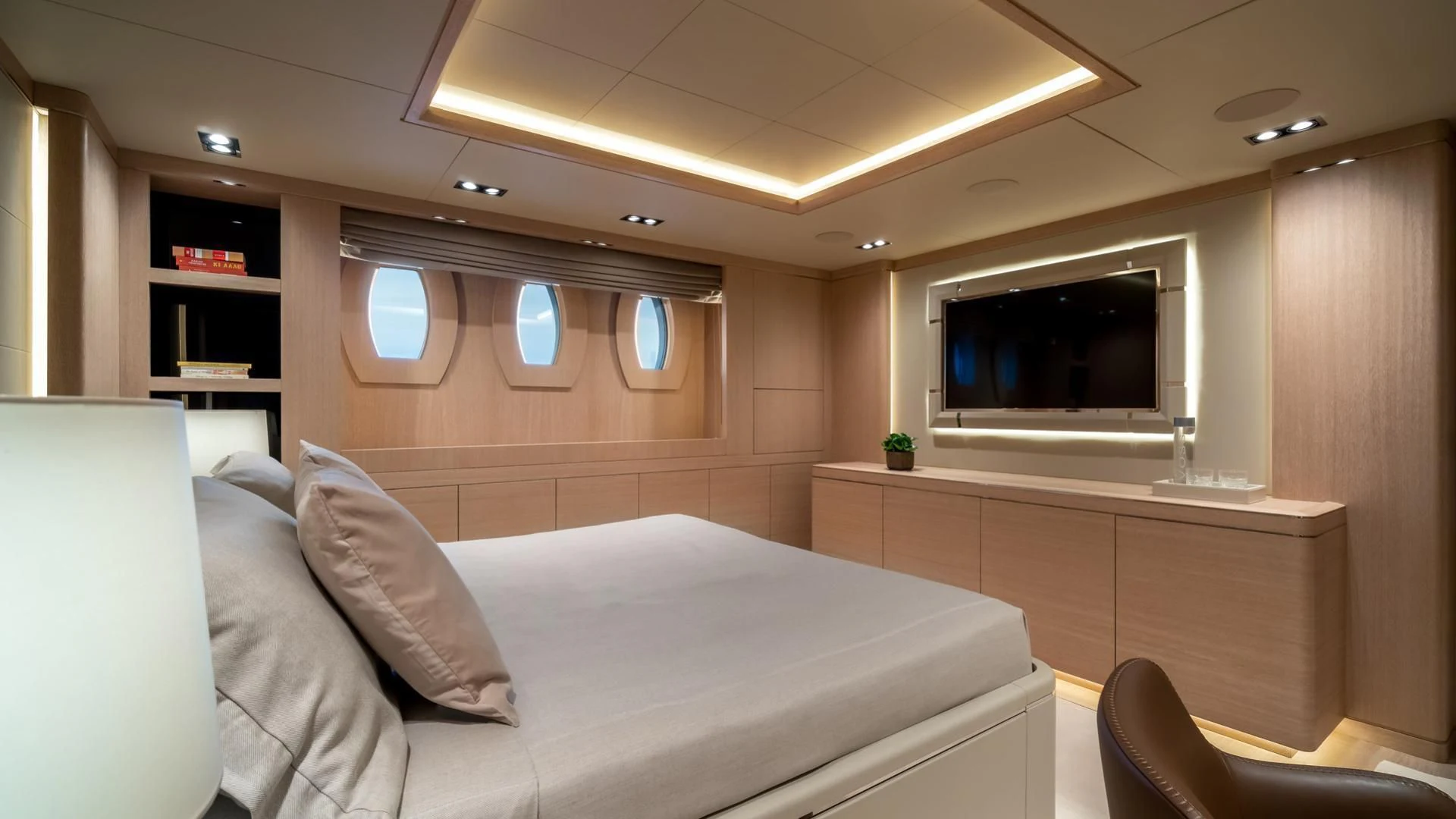 a room with a bed and a tv aboard JAZ Yacht for Charter