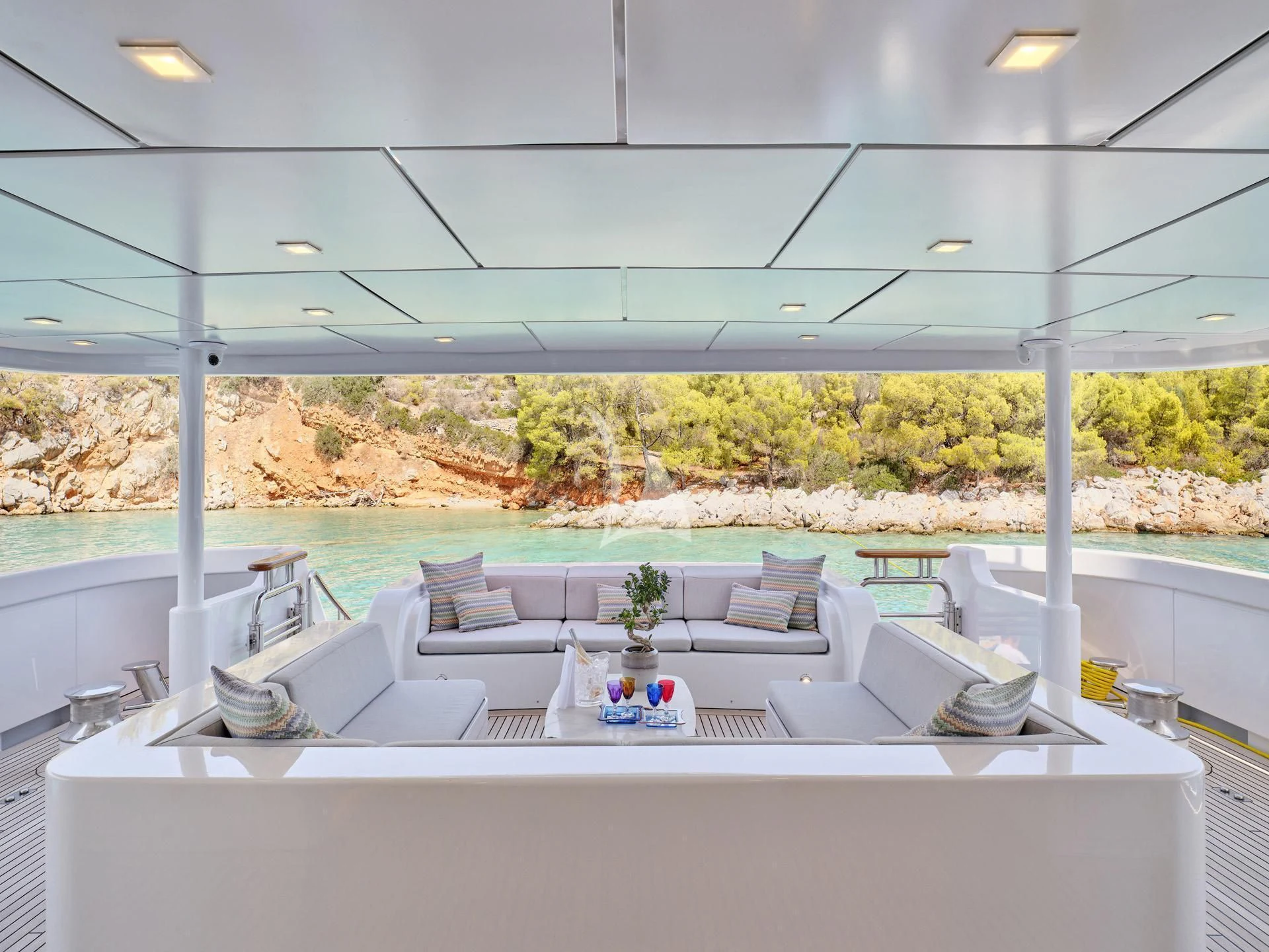 a large white table with chairs aboard JAZ Yacht for Charter