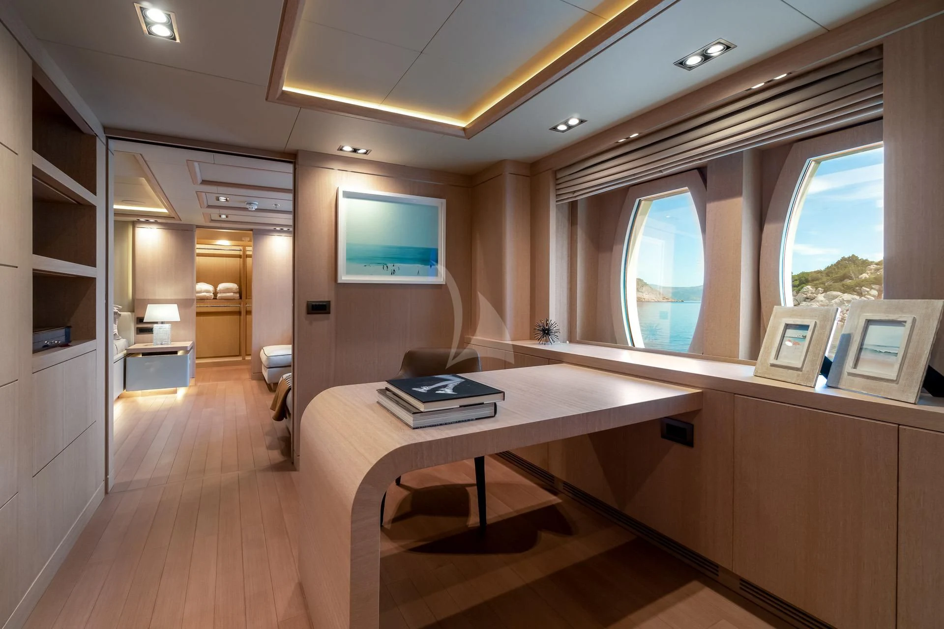 a room with a desk and a tv on the wall aboard JAZ Yacht for Charter