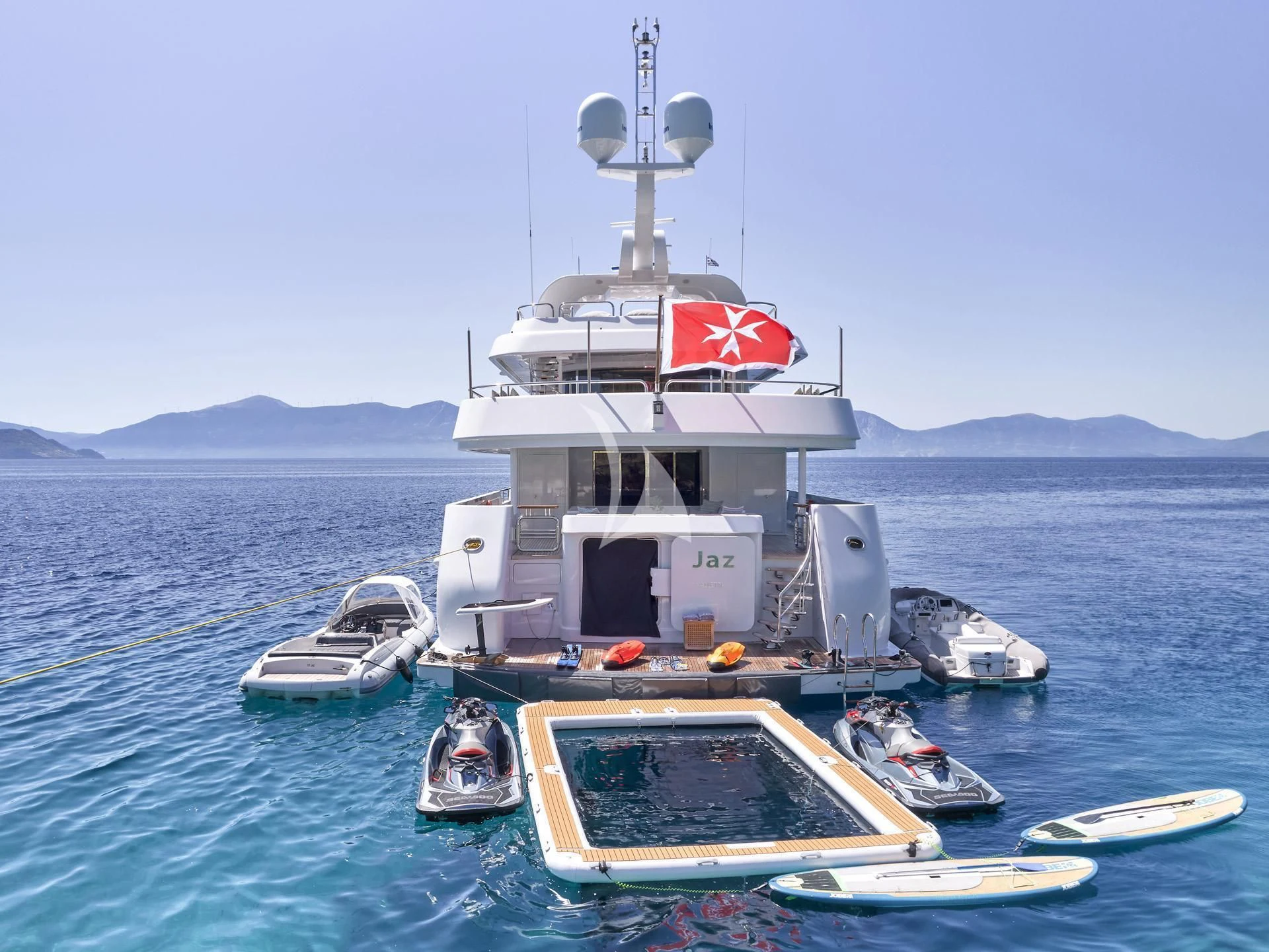 a large white boat with a red and black stripe on it aboard JAZ Yacht for Charter