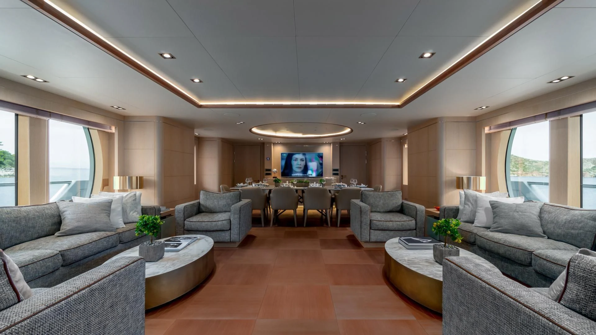 a living room with a large screen aboard JAZ Yacht for Charter