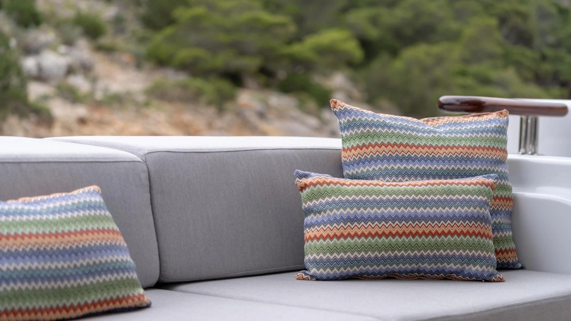 a couch with a pillow on it aboard JAZ Yacht for Charter