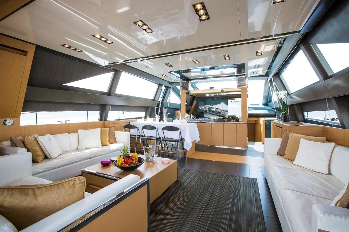 a room with a couch and a table and chairs aboard WHATEVER Yacht for Sale