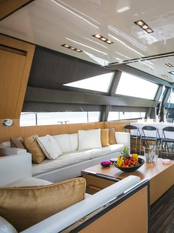 a room with a couch and a table with food on it aboard WHATEVER Yacht for Sale