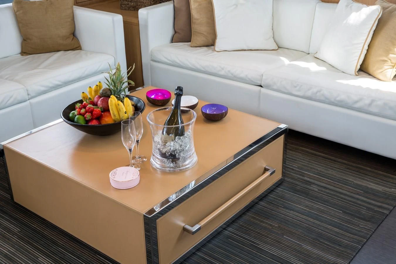 a glass of wine on a coffee table aboard WHATEVER Yacht for Sale