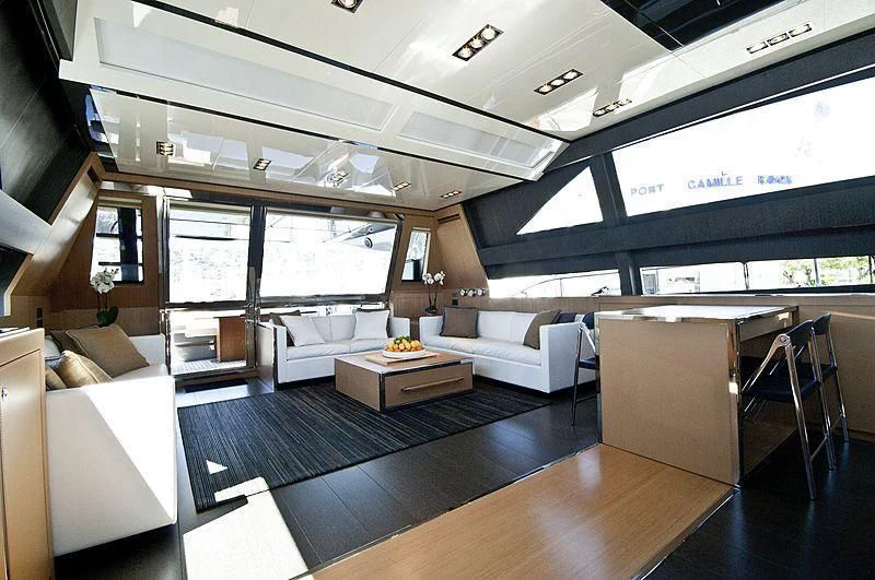 a room with a table and couches aboard WHATEVER Yacht for Sale