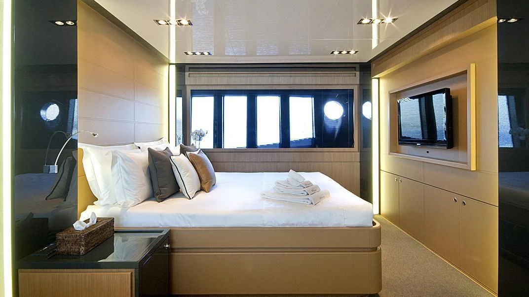 a room with a bed and a television aboard WHATEVER Yacht for Sale