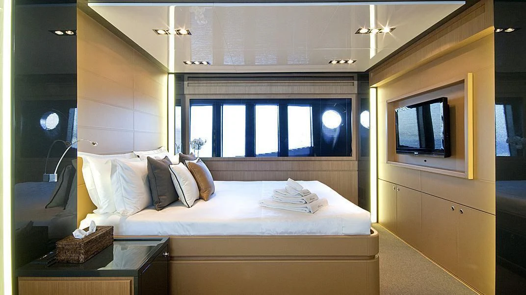 a room with a bed and a television aboard WHATEVER Yacht for Sale