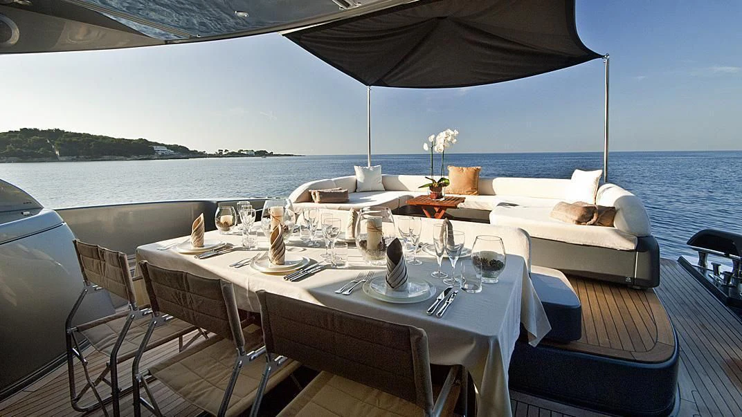 a table set for a dinner on a boat aboard WHATEVER Yacht for Sale