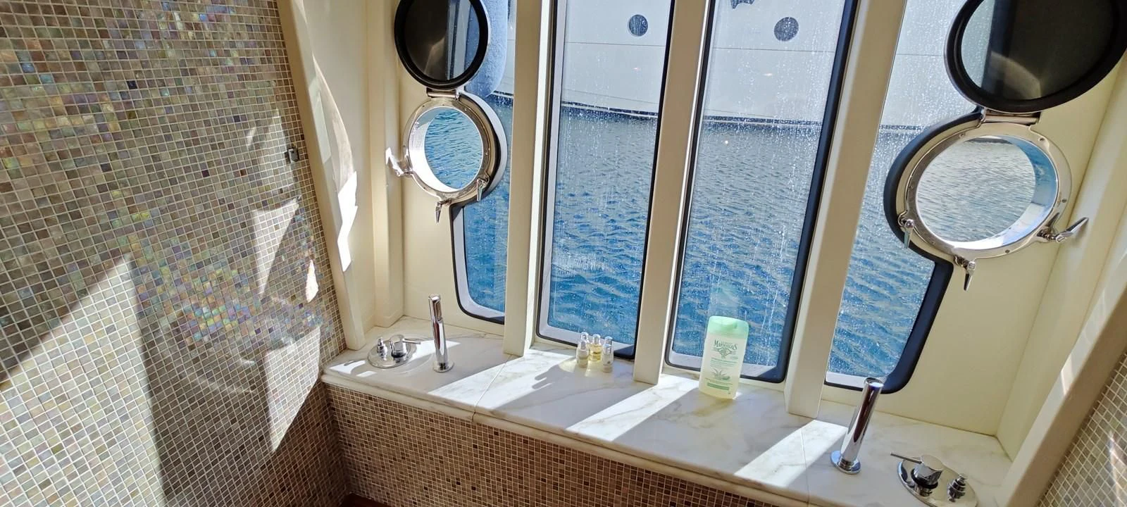 a bathroom with a large mirror aboard MAYBE NOT Yacht for Sale