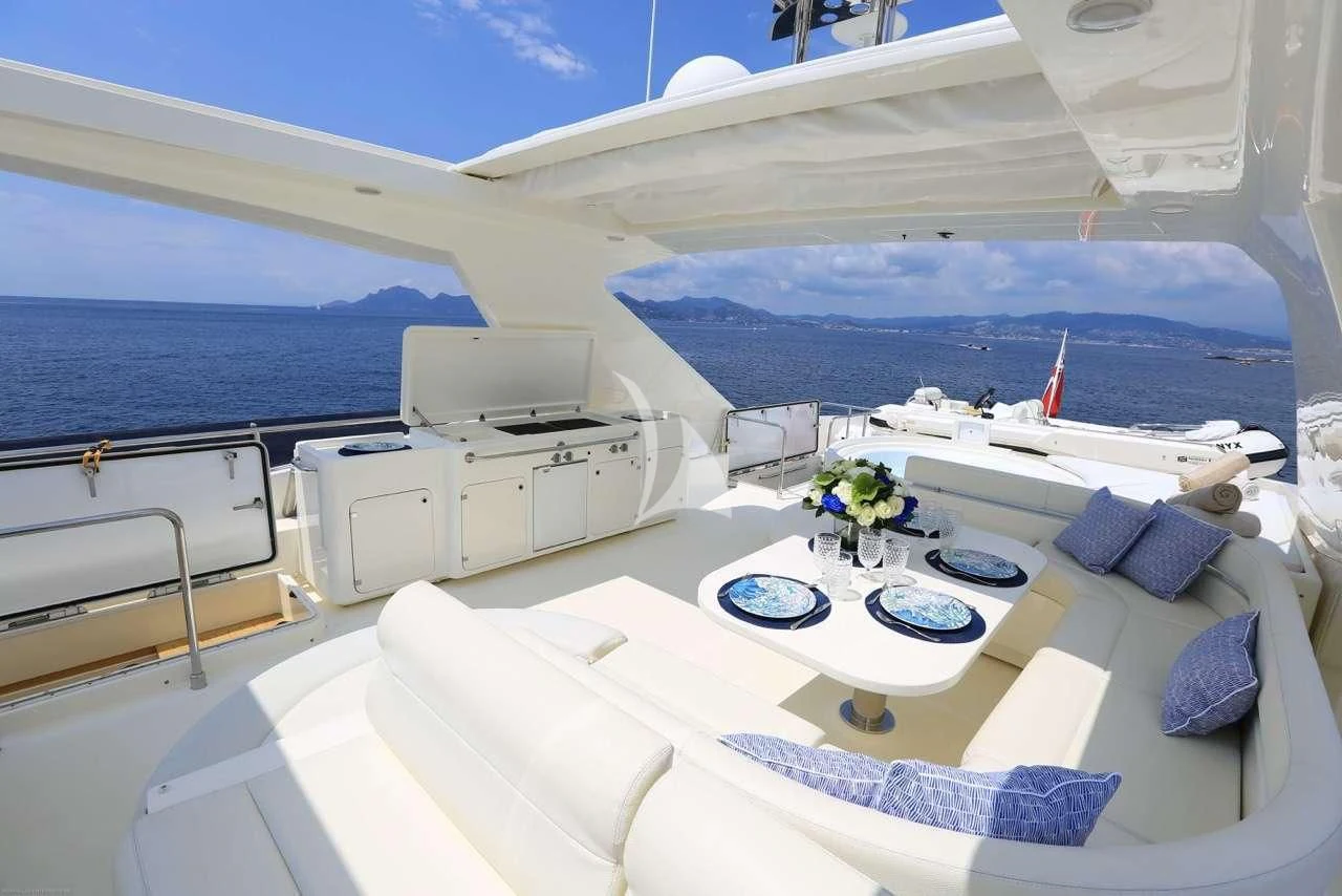 a large white bed with a white bed and blue pillows aboard MAYBE NOT Yacht for Sale