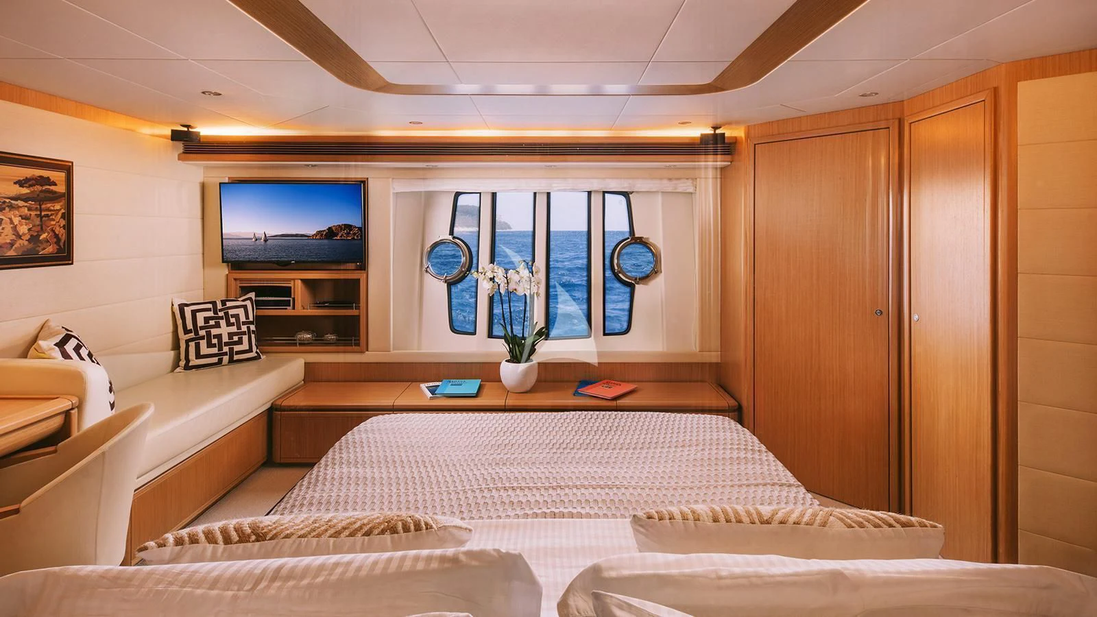 a room with a couch and a television aboard MAYBE NOT Yacht for Sale