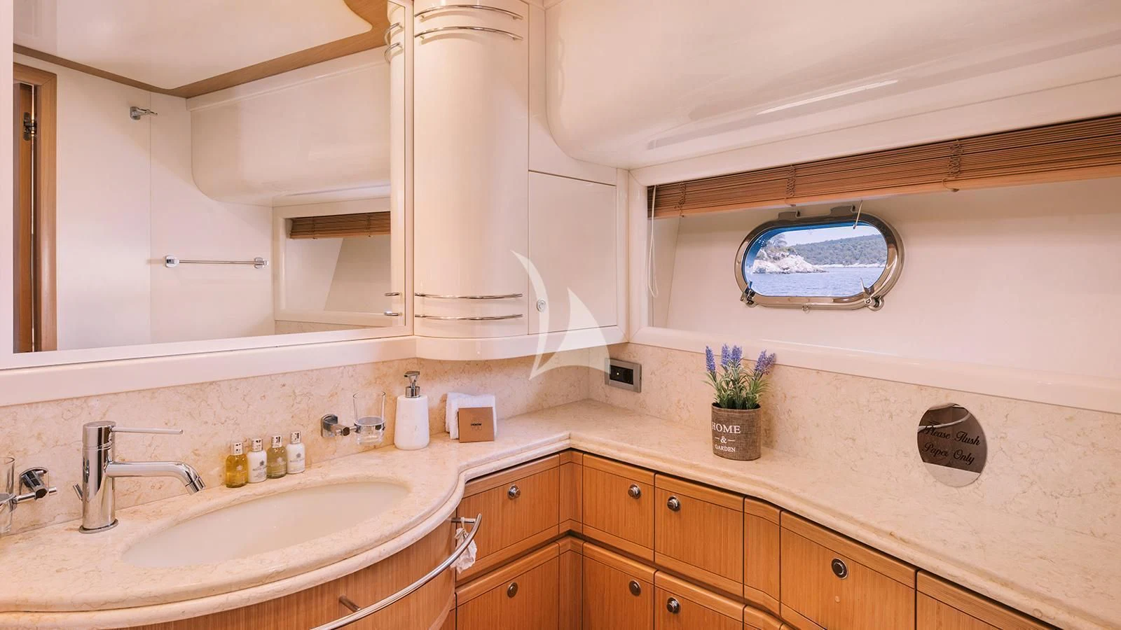 a bathroom with a sink and a mirror aboard MAYBE NOT Yacht for Sale