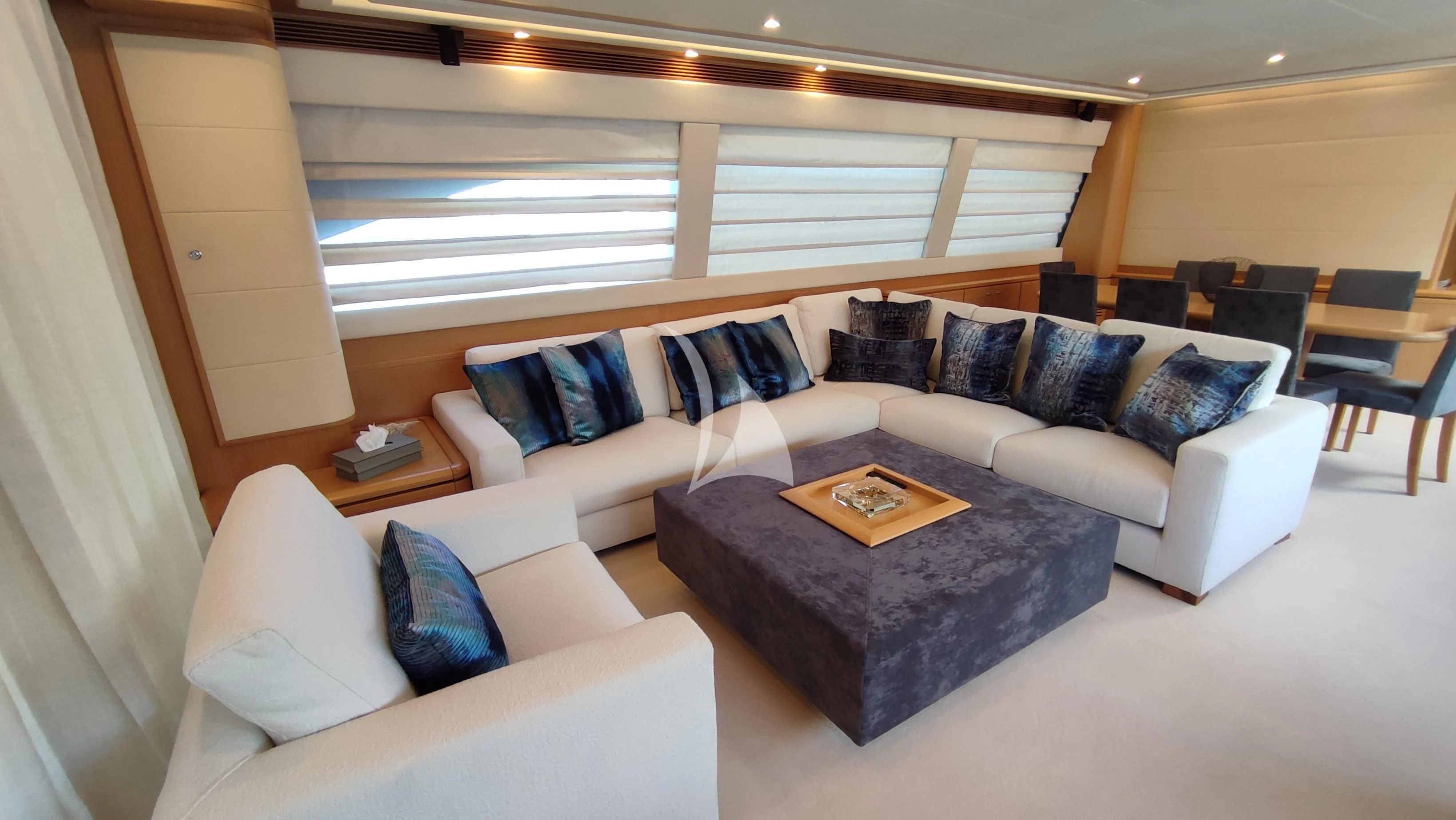 a large living room with a couch and a coffee table aboard MAYBE NOT Yacht for Sale