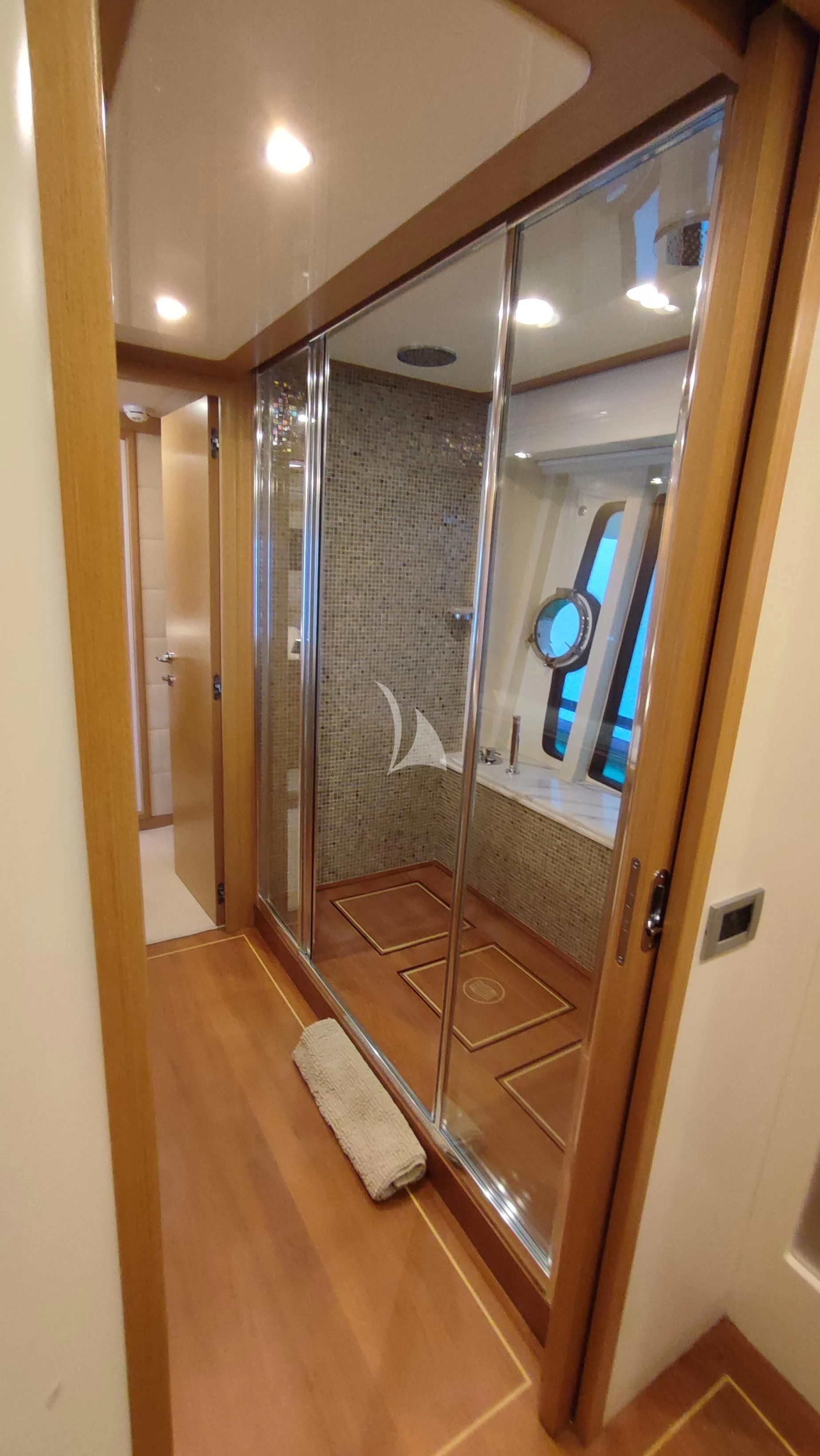 a bathroom with a glass shower aboard MAYBE NOT Yacht for Sale