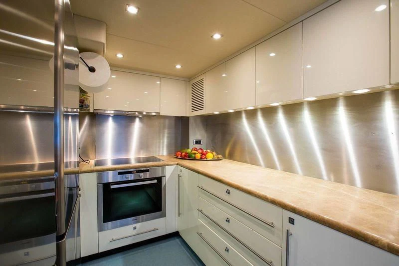 a kitchen with a microwave oven and a refrigerator aboard FRIVOLOUS Yacht for Sale