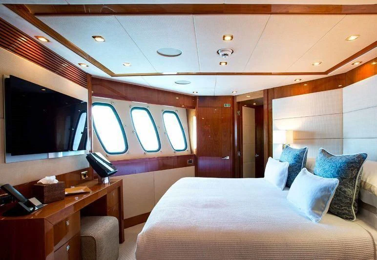 a room with a bed and a tv aboard FRIVOLOUS Yacht for Sale