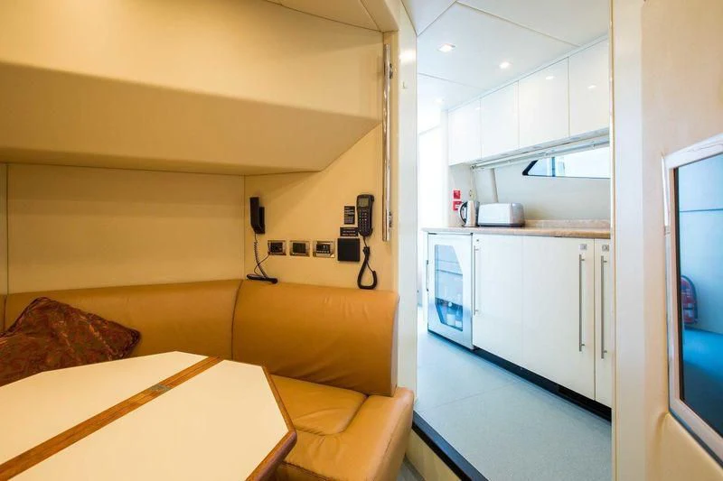 a room with a couch and a table aboard FRIVOLOUS Yacht for Sale