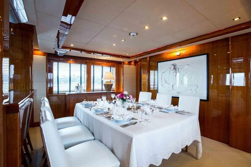 a room with a table and chairs aboard FRIVOLOUS Yacht for Sale