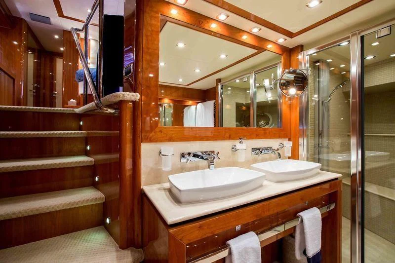 a bathroom with a sink and a mirror aboard FRIVOLOUS Yacht for Sale