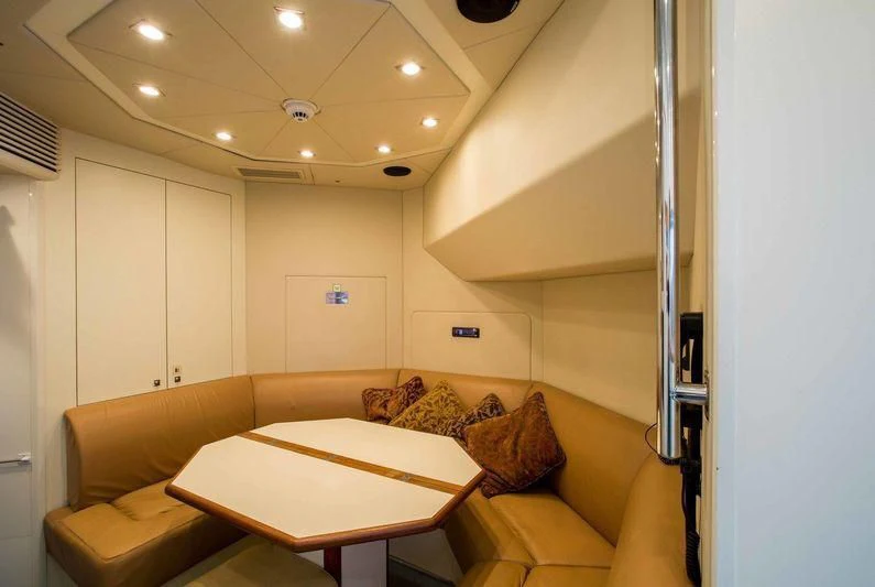 a living room with a couch and a table aboard FRIVOLOUS Yacht for Sale