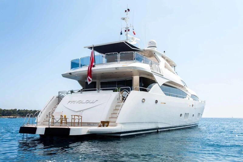 a large white boat in the water aboard FRIVOLOUS Yacht for Sale