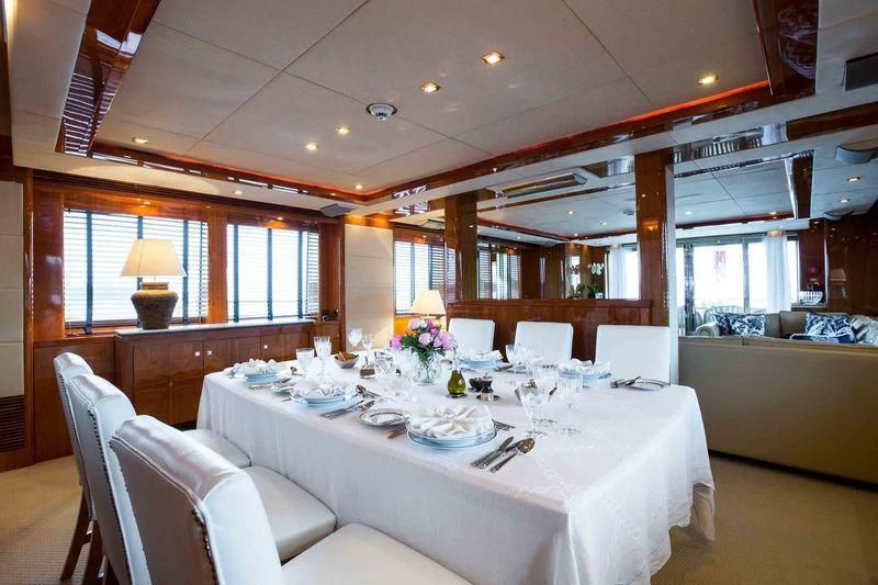 a dining table set for a meal aboard FRIVOLOUS Yacht for Sale