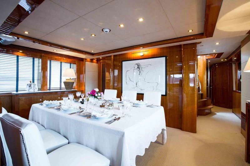 a room with a table and chairs aboard FRIVOLOUS Yacht for Sale