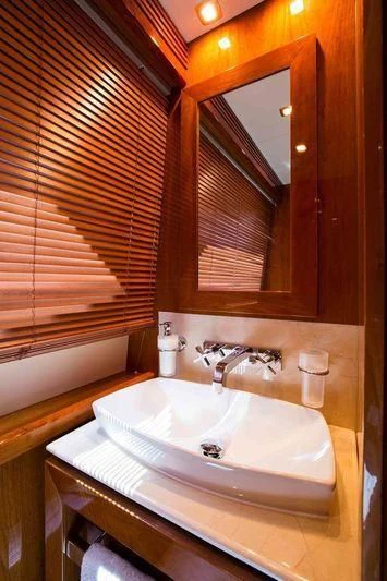 a bathroom with a sink and a mirror aboard FRIVOLOUS Yacht for Sale