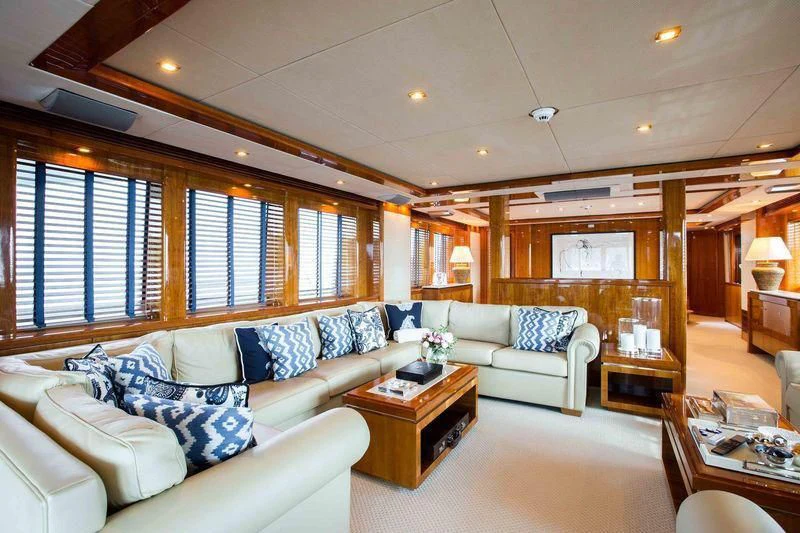 a living room with a couch and a coffee table aboard FRIVOLOUS Yacht for Sale