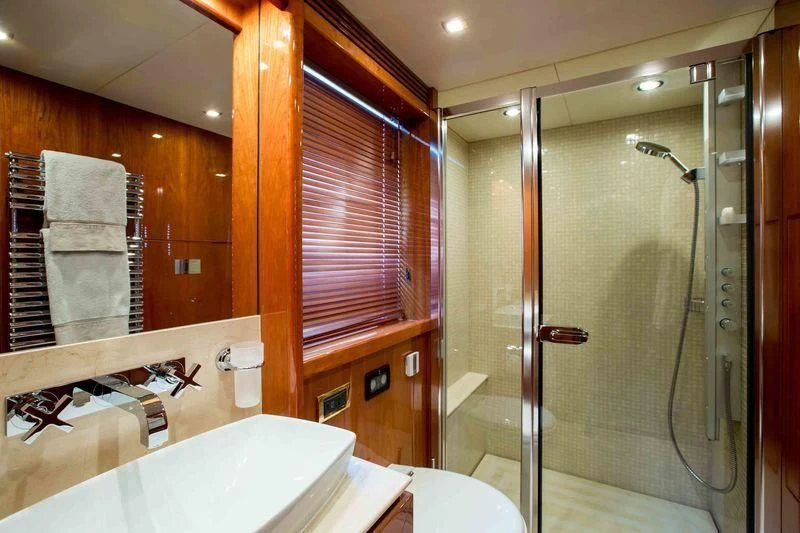 a bathroom with a glass shower aboard FRIVOLOUS Yacht for Sale