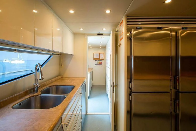 a kitchen with stainless steel appliances aboard FRIVOLOUS Yacht for Sale