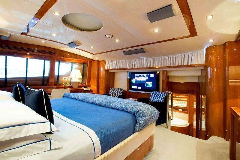 a room with a bed and a television aboard FRIVOLOUS Yacht for Sale