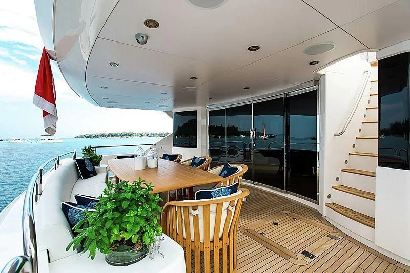 a room with a table and chairs aboard FRIVOLOUS Yacht for Sale