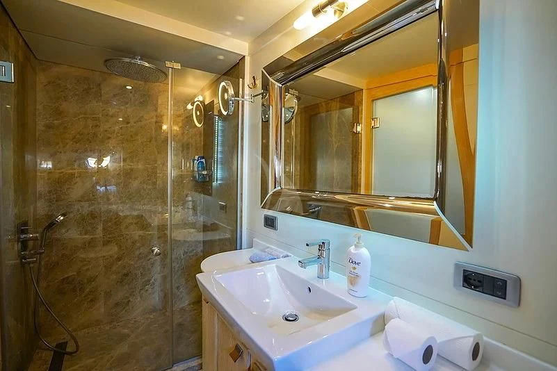 a bathroom with a large mirror aboard TUYIKA S Yacht for Sale