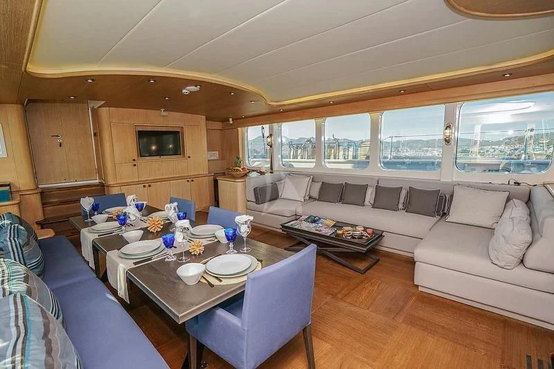 a living room with a couch and a table aboard TUYIKA S Yacht for Sale